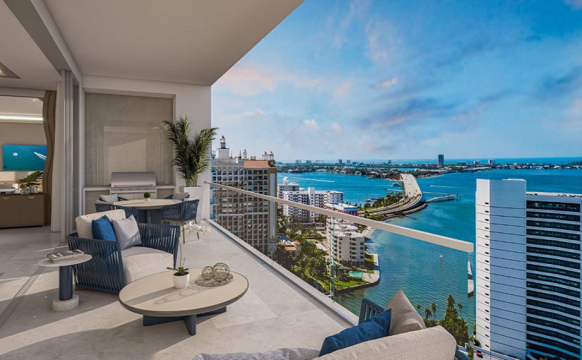 A sprawling, modern balcony at the Ritz-Carlton Residences Sarasota, featuring sleek glass railings and premium stone flooring, overlooking the turquoise waters of Sarasota Bay and the downtown marina under a clear Florida sky.